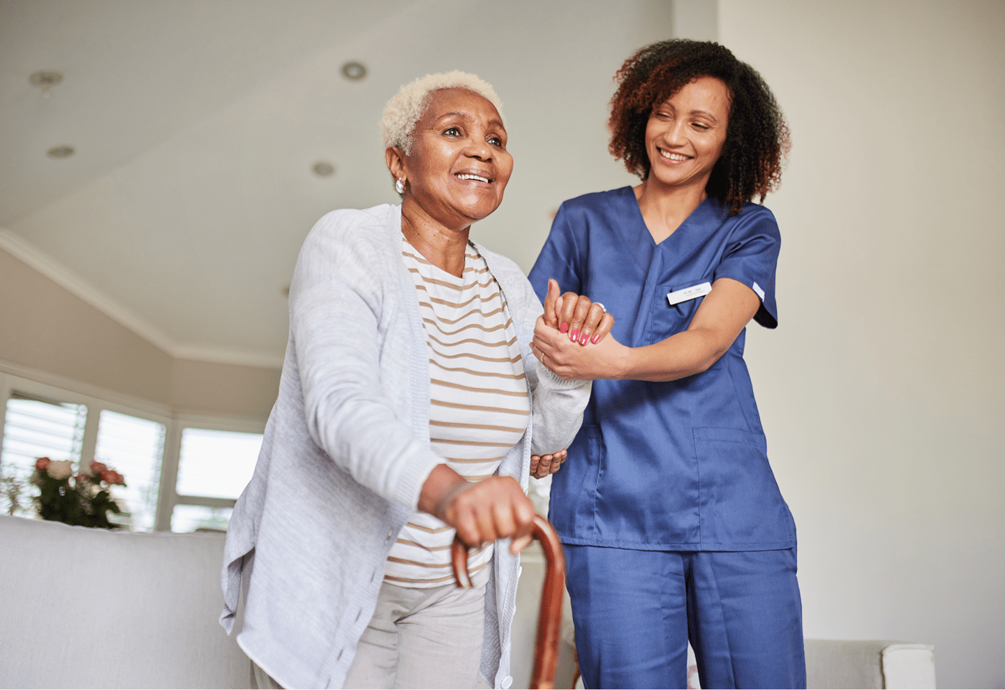 Elderly woman assisted by healthcare worker.